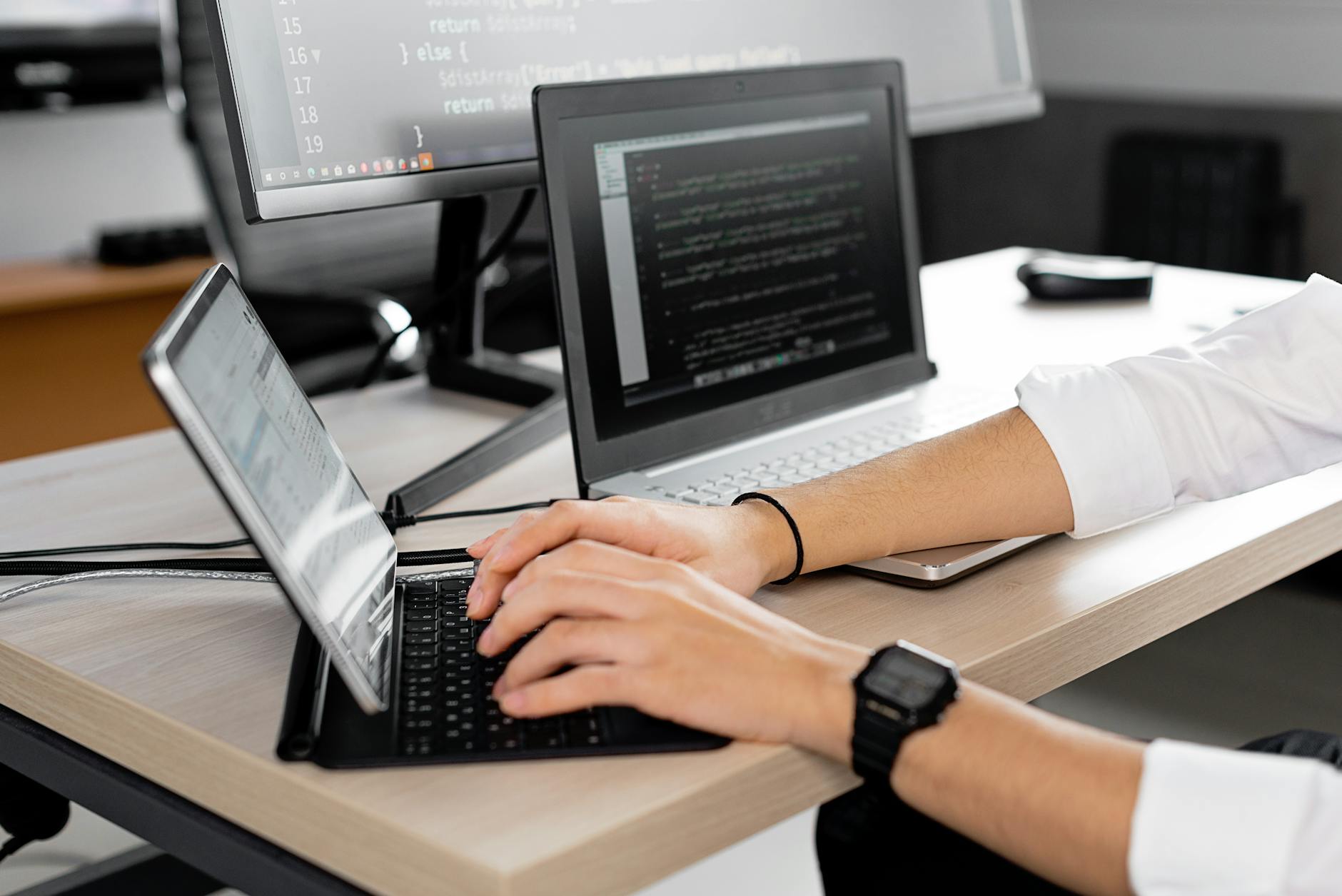 Developer typing on a mechanical keyboard in warm desk light